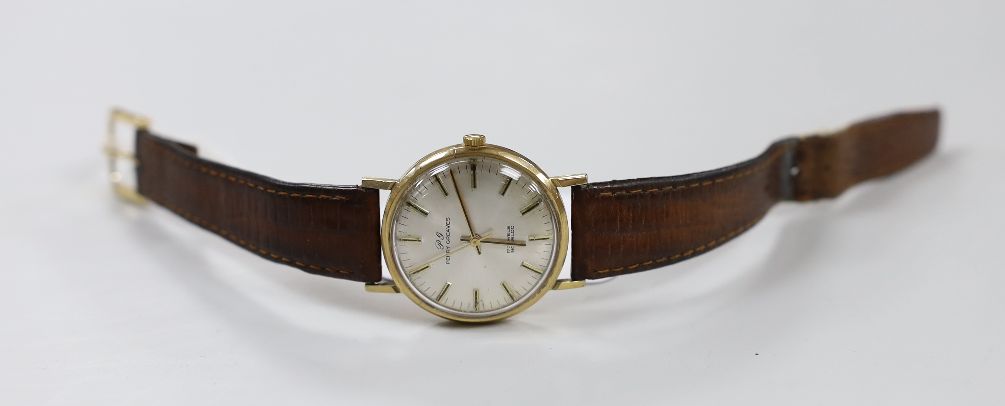 A gentleman's yellow metal Perry Greaves manual wind wrist watch, with case back inscription.